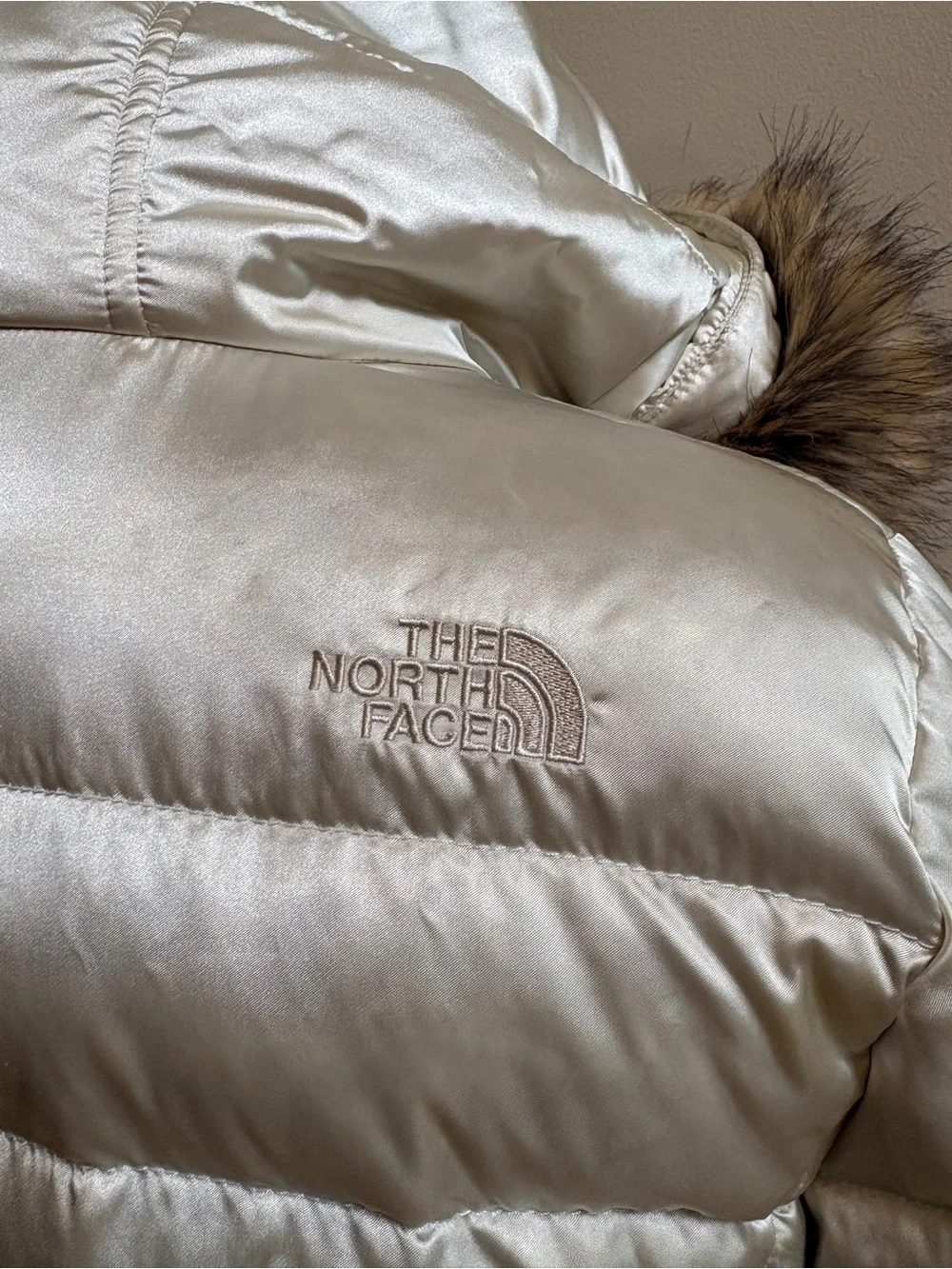 The North Face Girls champagne-colored puffer jacket